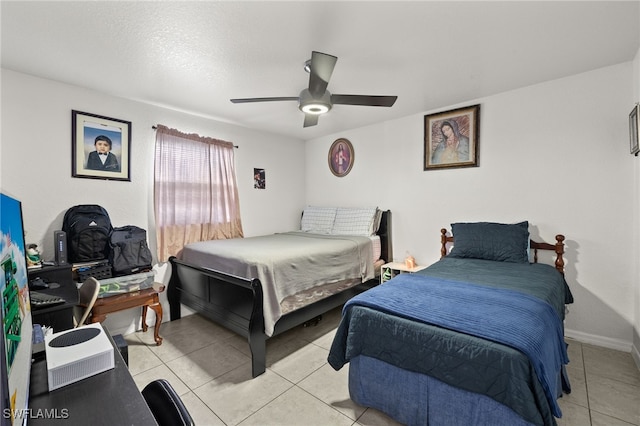 bedroom with ceiling fan and light tile patterned flooring