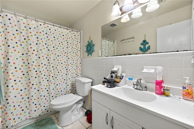 bathroom with toilet, tile patterned floors, tile walls, a shower with shower curtain, and vanity