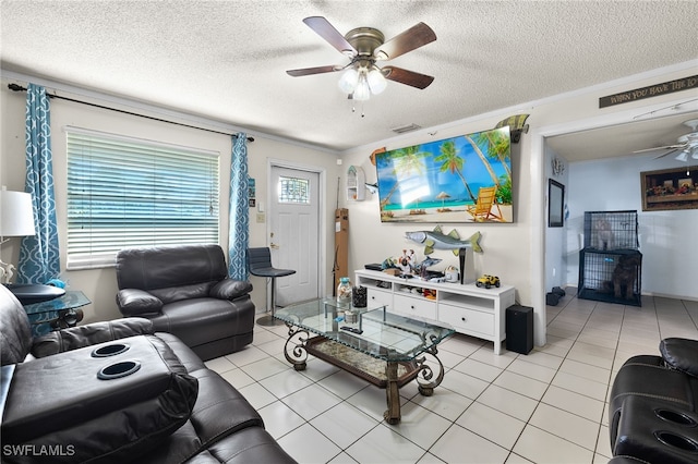 living room with light tile patterned flooring, crown molding, ceiling fan, and a textured ceiling