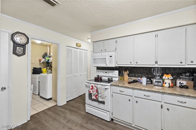 kitchen with white cabinets, backsplash, hardwood / wood-style floors, and white appliances