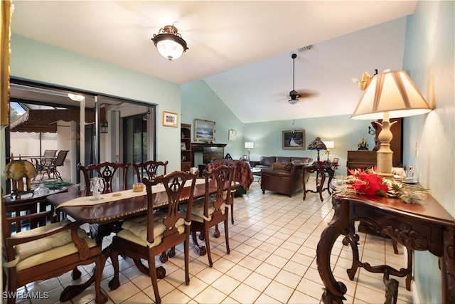 tiled dining area featuring lofted ceiling and ceiling fan