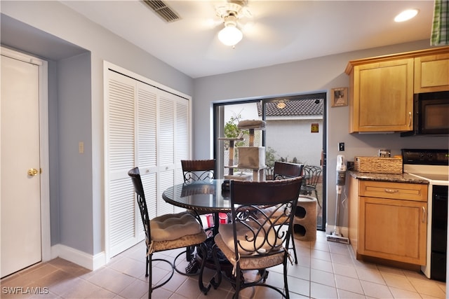 tiled dining room featuring ceiling fan