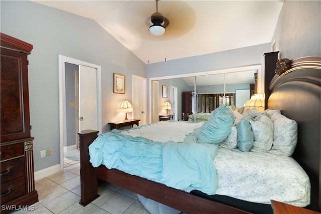 tiled bedroom featuring a closet, vaulted ceiling, and ceiling fan