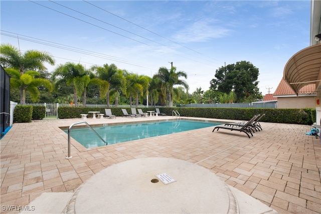 view of swimming pool with a patio