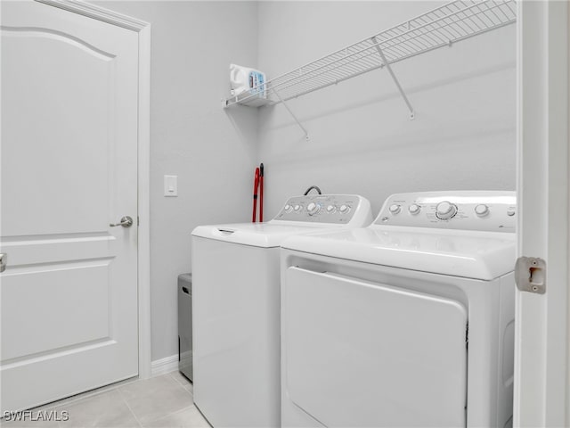 laundry room featuring light tile patterned floors and washing machine and dryer