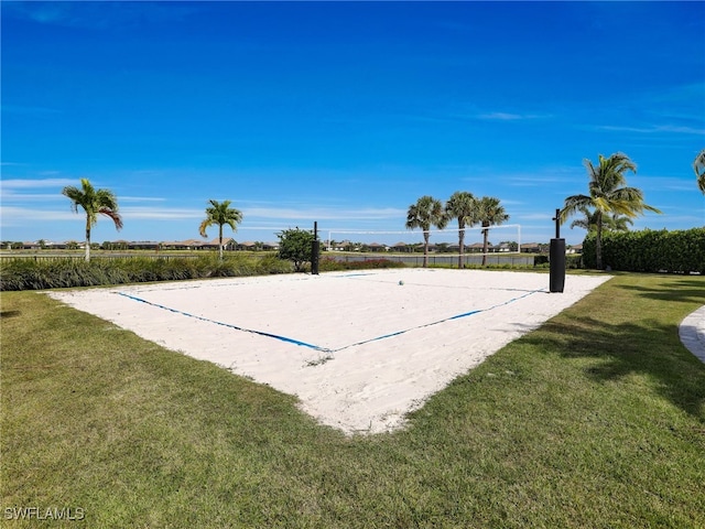 view of property's community with volleyball court and a lawn