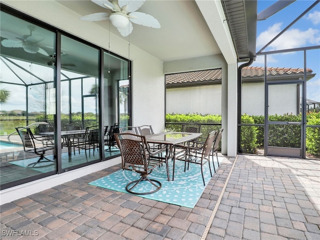 sunroom / solarium featuring ceiling fan