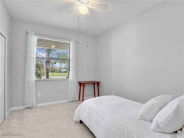 bedroom featuring ceiling fan and light carpet