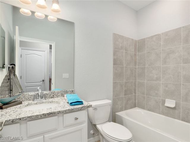 full bathroom with vanity, tiled shower / bath combo, and toilet