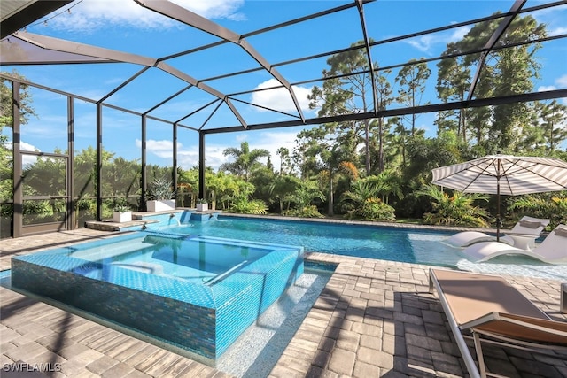 view of swimming pool with an in ground hot tub, a lanai, and a patio area