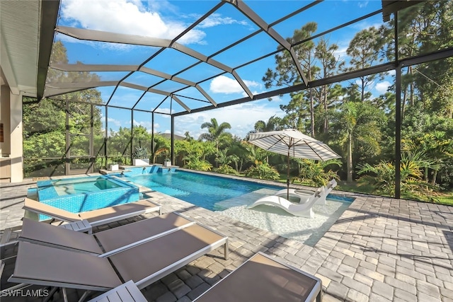 view of pool featuring a patio, an in ground hot tub, and a lanai