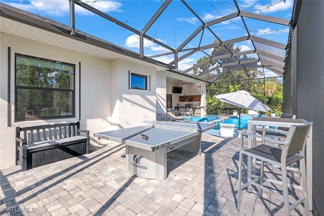 view of patio featuring a lanai