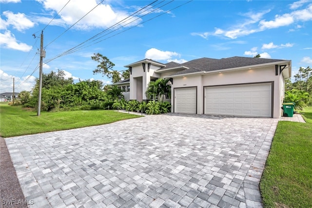 view of front of home featuring a garage and a front lawn