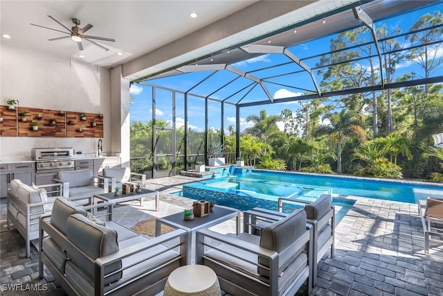 view of pool featuring area for grilling, ceiling fan, and sink