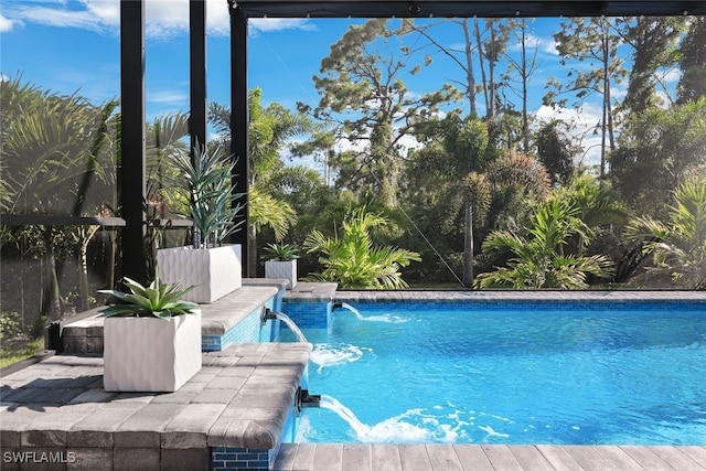 view of swimming pool with pool water feature