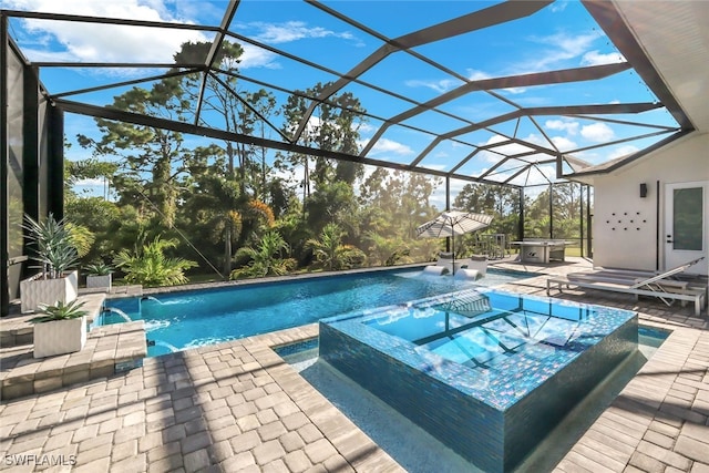 view of pool with a patio, an in ground hot tub, a lanai, and pool water feature