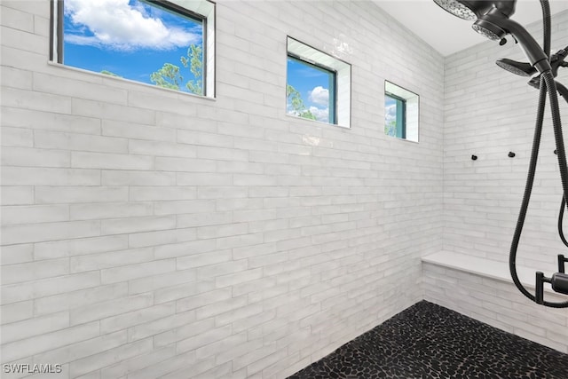 bathroom with tiled shower