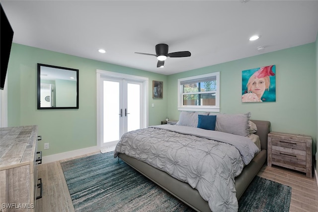 bedroom featuring ceiling fan, access to exterior, light wood-type flooring, and french doors