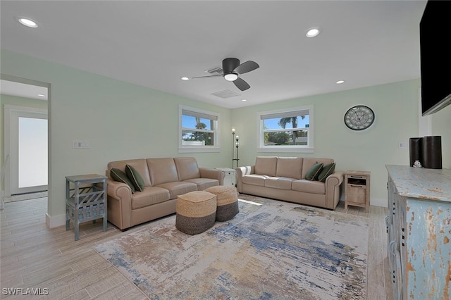 living room with ceiling fan and light hardwood / wood-style flooring