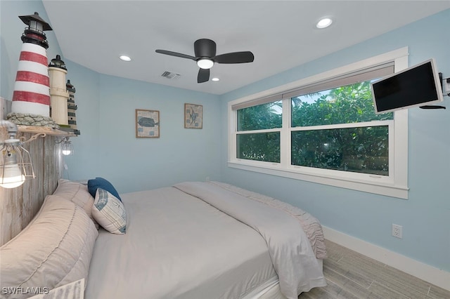 bedroom featuring ceiling fan and light hardwood / wood-style flooring