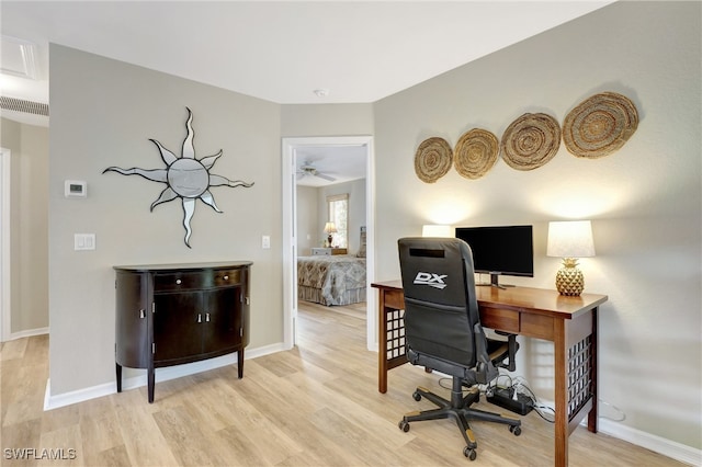 home office featuring ceiling fan and light hardwood / wood-style floors