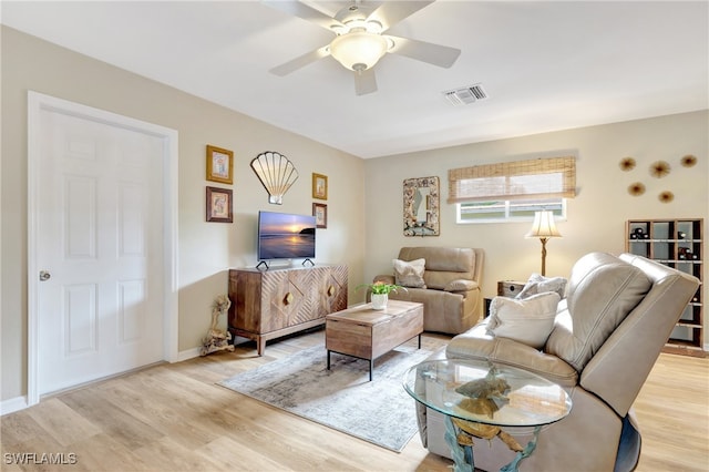 living room featuring light wood-type flooring and ceiling fan