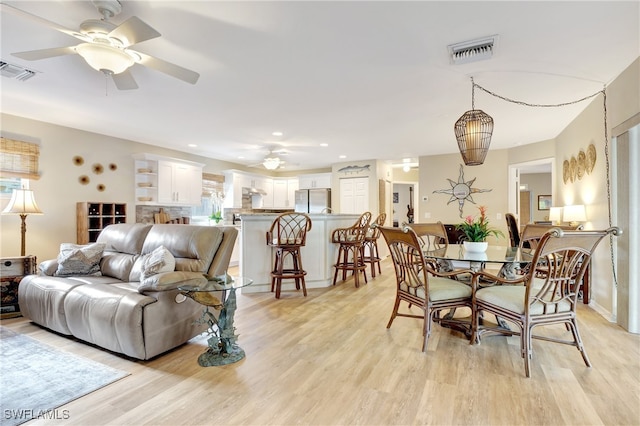 dining room featuring ceiling fan and light wood-type flooring