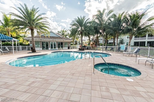 view of swimming pool with a hot tub and a patio