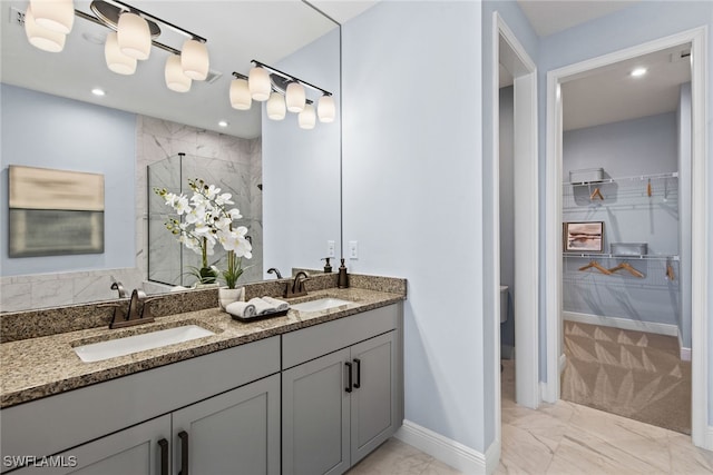 bathroom featuring vanity and tiled shower