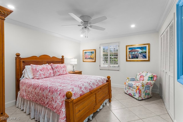 bedroom featuring ceiling fan, ornamental molding, light tile patterned floors, and a closet