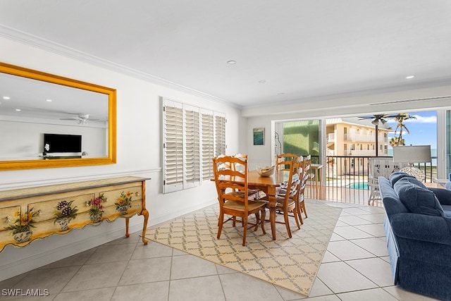 dining space with light tile patterned floors, ceiling fan, and ornamental molding