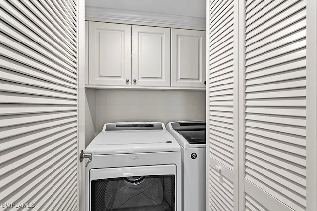 laundry area with cabinets and washing machine and clothes dryer