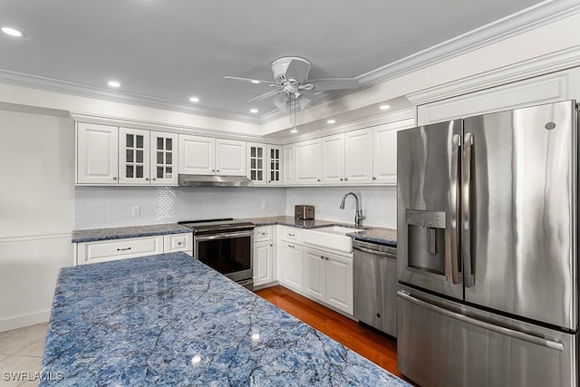 kitchen with sink, white cabinets, dark stone counters, and appliances with stainless steel finishes