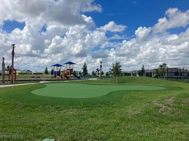 view of community with a lawn and a playground