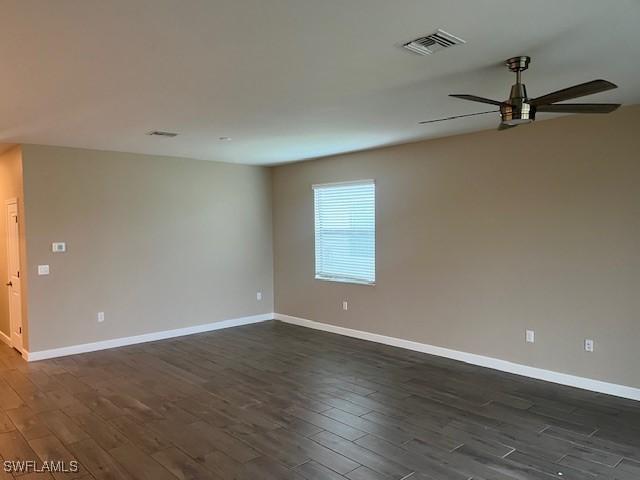 unfurnished room featuring ceiling fan and dark hardwood / wood-style flooring