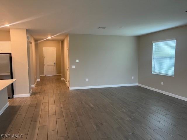 spare room featuring dark hardwood / wood-style flooring