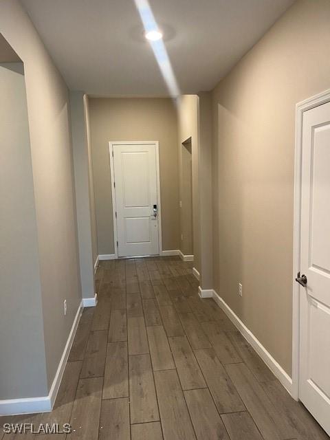 corridor featuring dark wood-type flooring