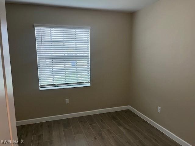 empty room with dark wood-type flooring