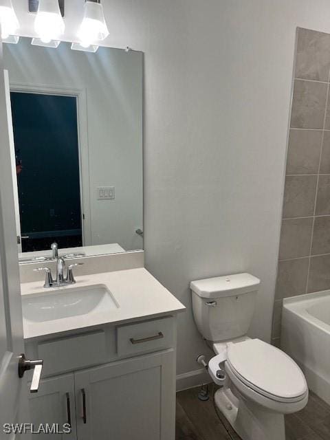 bathroom featuring hardwood / wood-style flooring, vanity, and toilet