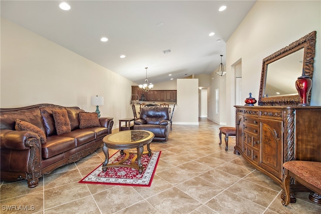 living room with high vaulted ceiling and an inviting chandelier