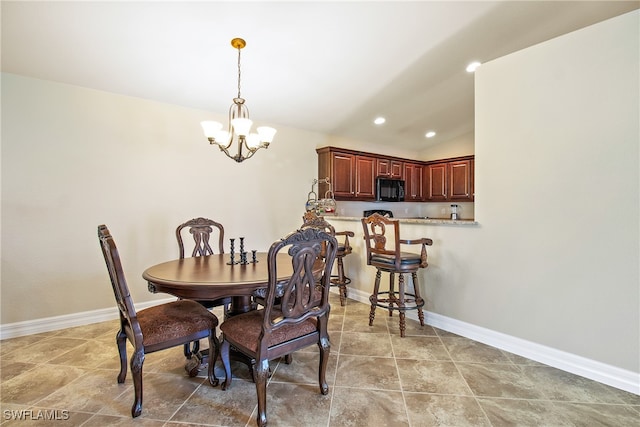 dining space featuring an inviting chandelier and vaulted ceiling