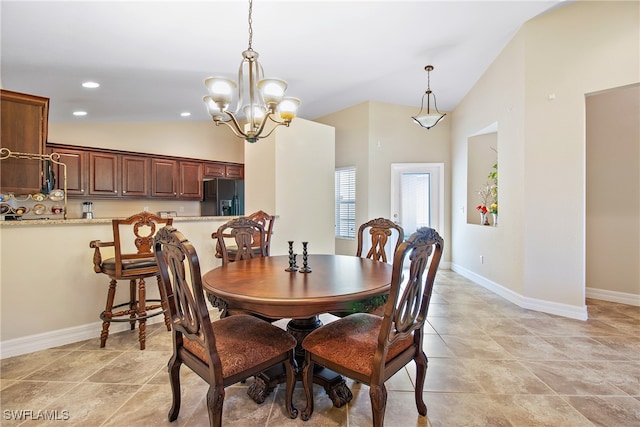 dining room featuring a chandelier and vaulted ceiling