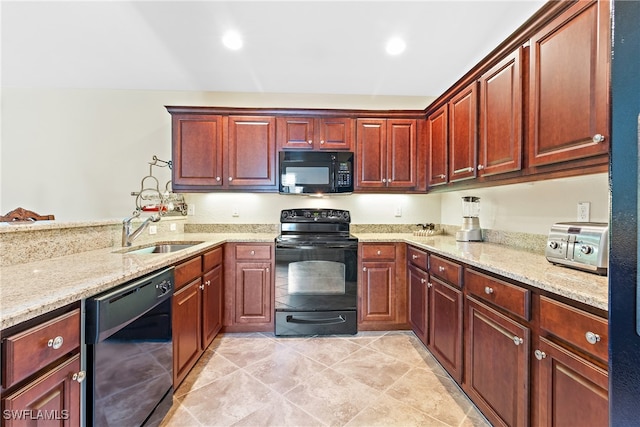 kitchen with sink, black appliances, light stone countertops, and kitchen peninsula