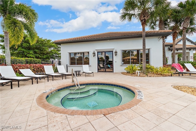 view of pool with an in ground hot tub and a patio