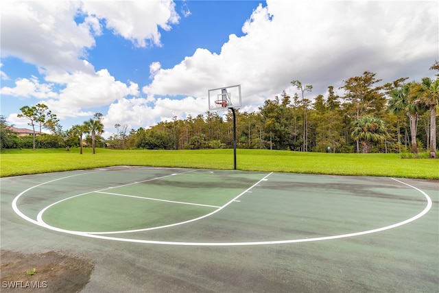 view of basketball court with a lawn