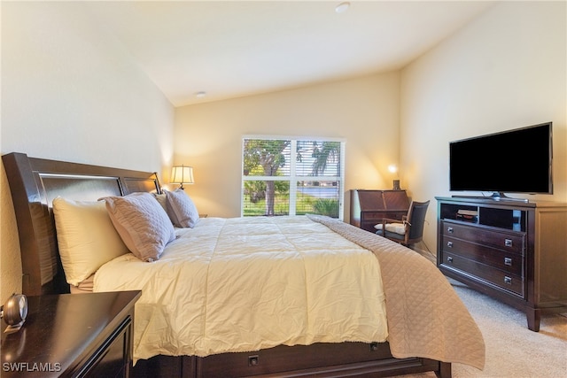 carpeted bedroom featuring vaulted ceiling