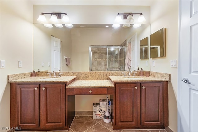 bathroom featuring a shower with door, vanity, and tile patterned flooring