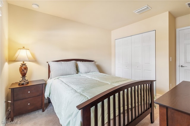 bedroom with a closet and light colored carpet