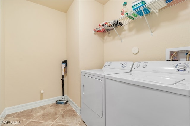 clothes washing area featuring washer and dryer and light tile patterned flooring