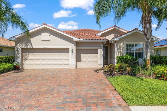 view of front of house with a garage and a front yard